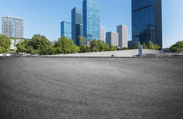 Empty road floor surface with modern city landmark buildings in China