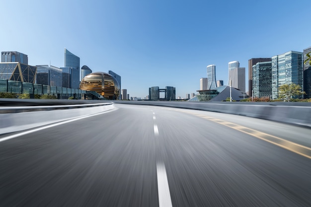 Empty road floor surface with modern city landmark buildings 