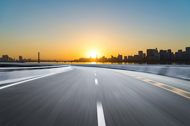 Empty road floor surface with modern city landmark buildings 