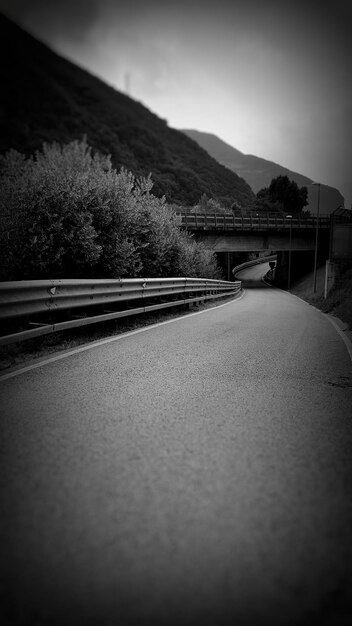 Foto una strada vuota che porta verso le montagne contro il cielo