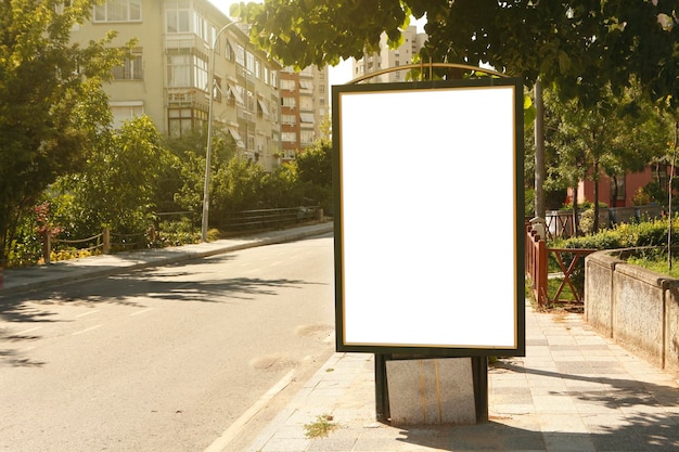empty road sign against trees in city