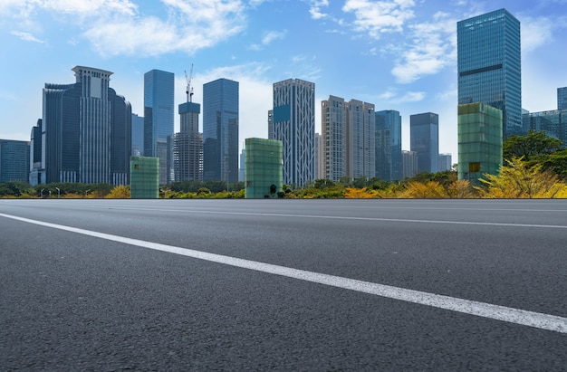 Empty road with panoramic cityscape
