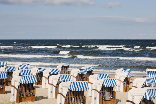 Empty roofed wicker beach chair at beach, Ruegen, Germany