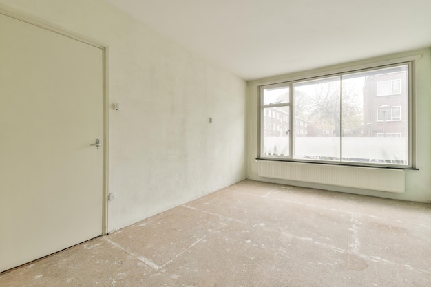 An empty room with large window