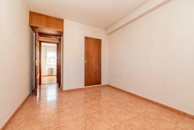 Empty room with orange stoneware floor white aluminum window and white painted walls