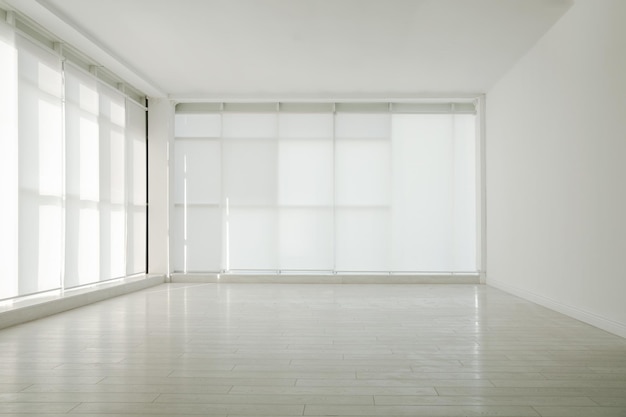 Empty room with panoramic windows and white wooden floor