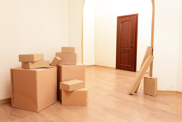 Empty room with stack of cartons moving house concept