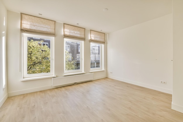 An empty room with three large windows