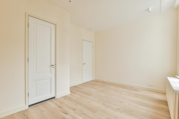 Empty room with white walls and parquet floor