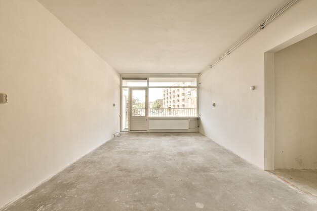 an empty room with a window and a door