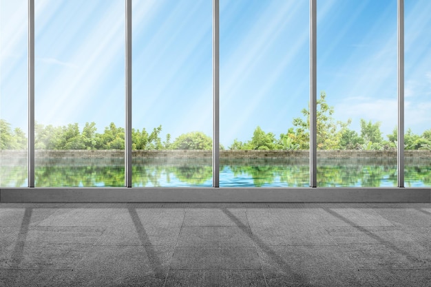 Empty room with window glass and lake with blue sky background