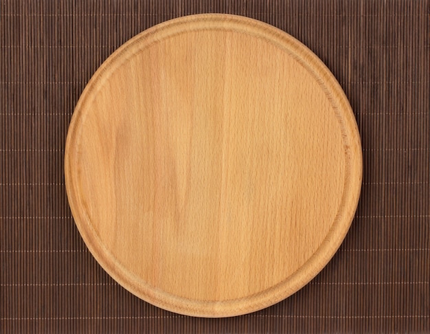 Empty round wooden board with tablecloth.