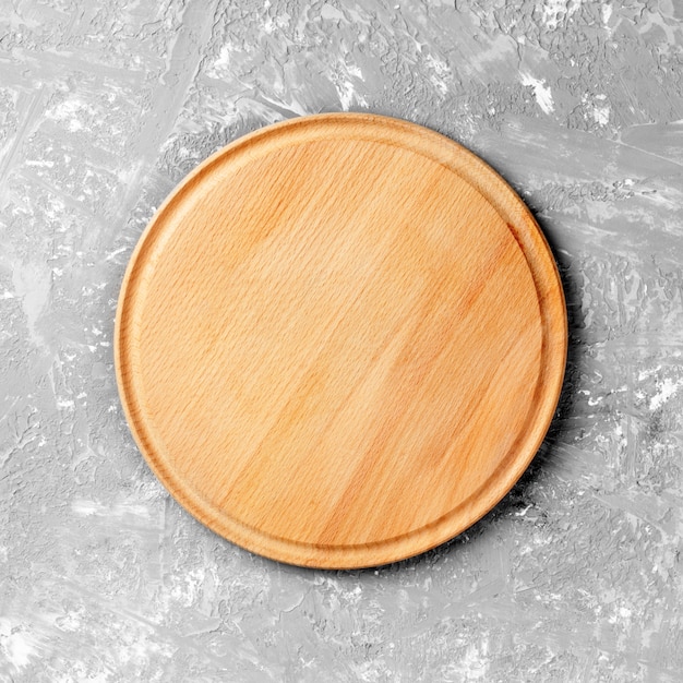 Empty round wooden dish on table 