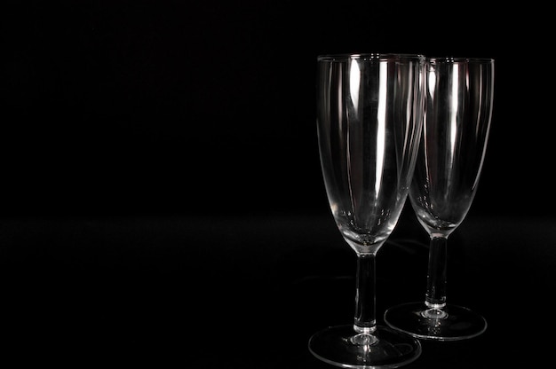 Empty сhampagne glass isolated on black background Closeup photo of  tumbler