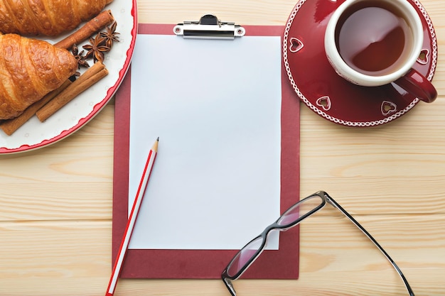 Empty sheet of white paper on the wooden table