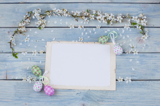 Empty sheets of paper, eggs and twigs of blooming white cherry