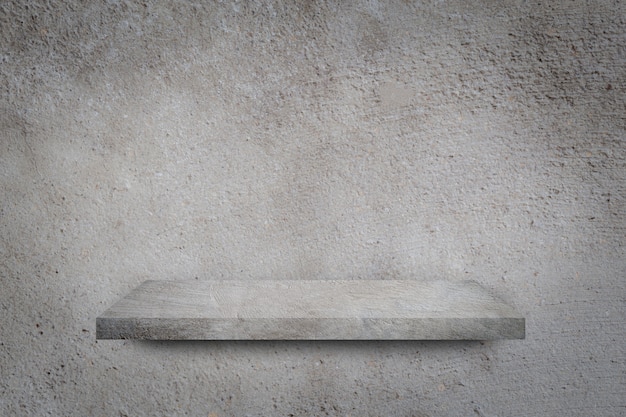 Empty shelf over grey concrete wall