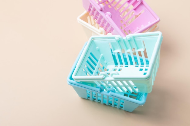 Empty shopping baskets on a beige background Minimalism Sales shopping prices concept