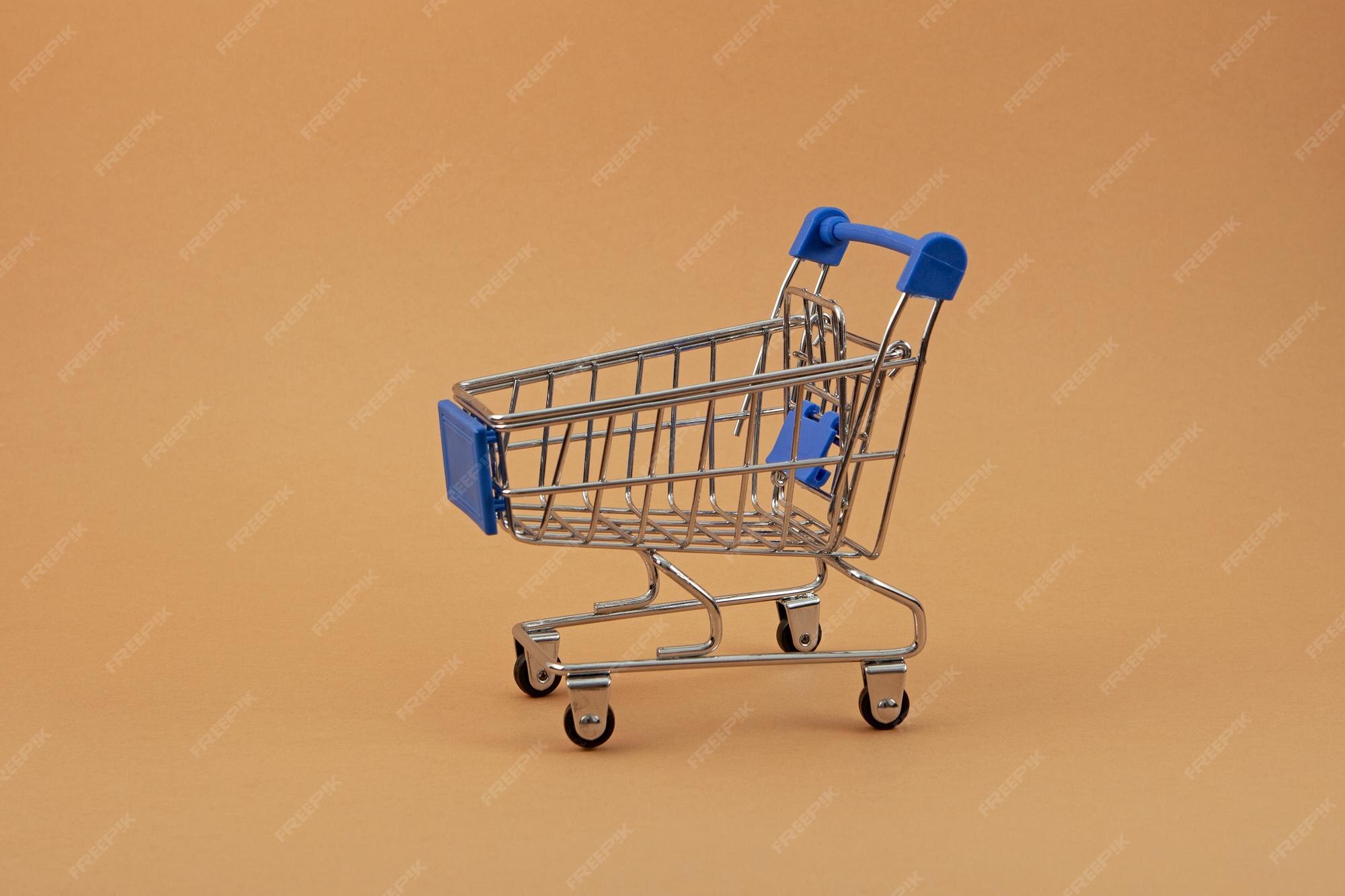 Premium Photo | Empty shopping cart on beige background side view