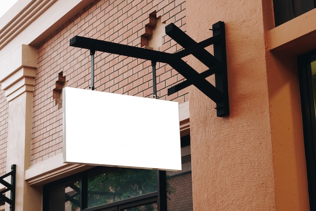 Empty signage and blank hanging on street with copy space