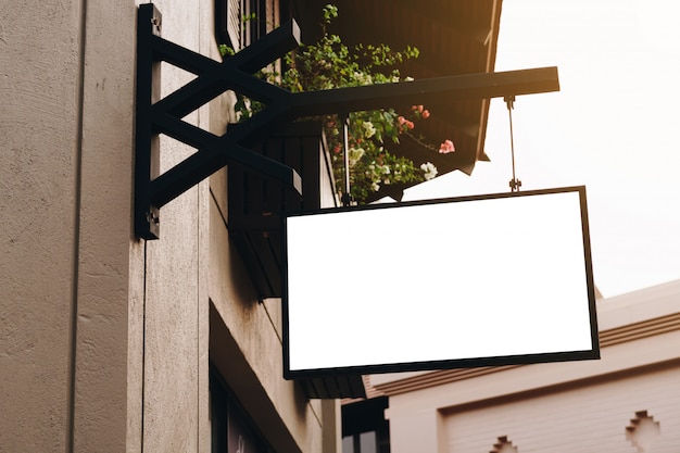 Empty signage and blank sign hanging on street