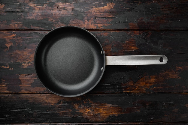 Empty skillet frying pan with copy space for text or food with copy space for text or food top view flat lay on old dark wooden table background