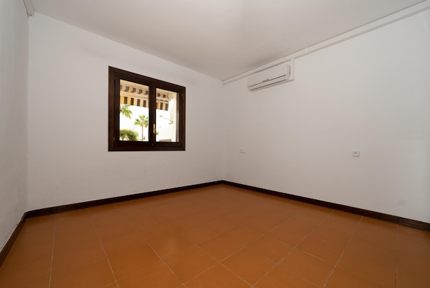 Empty sleeping room with white walls and a window