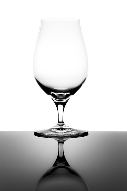 Photo empty snifter tasting glass and reflection isolated on white