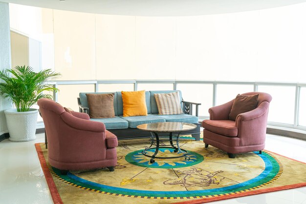 empty sofa and chair with pillows decoration in a room