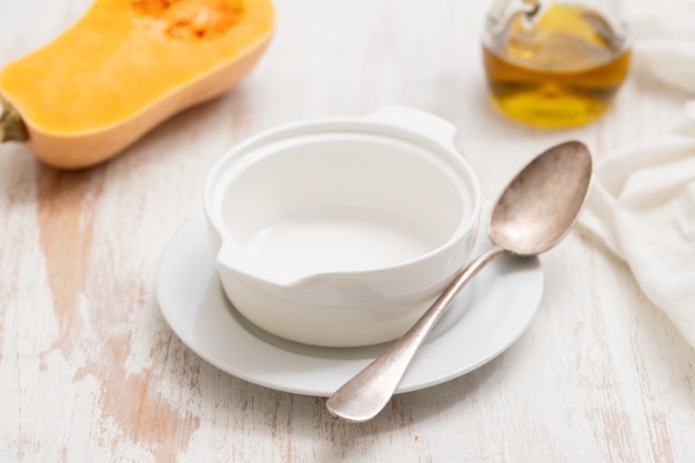 Empty soup bowl on white wooden table