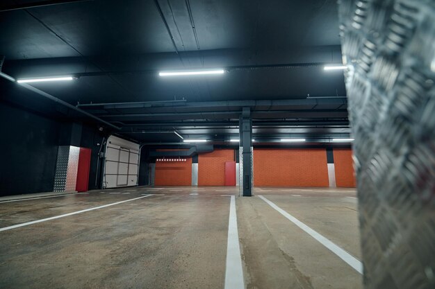 Empty spacious well-lit parking lot in the building