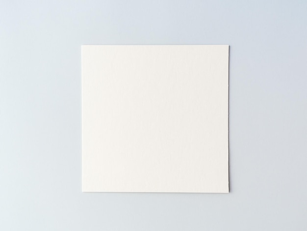 Photo empty square cardboard sheet on a on a blue background. empty space for text