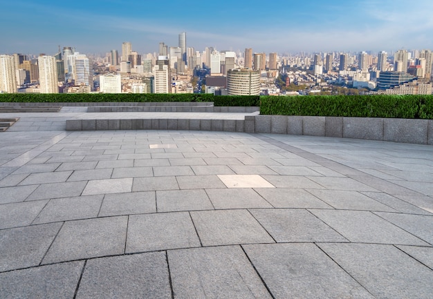 Empty square ground and city buildings background