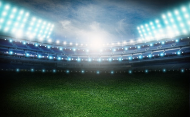 Empty stadium at night, green soccer field lighted