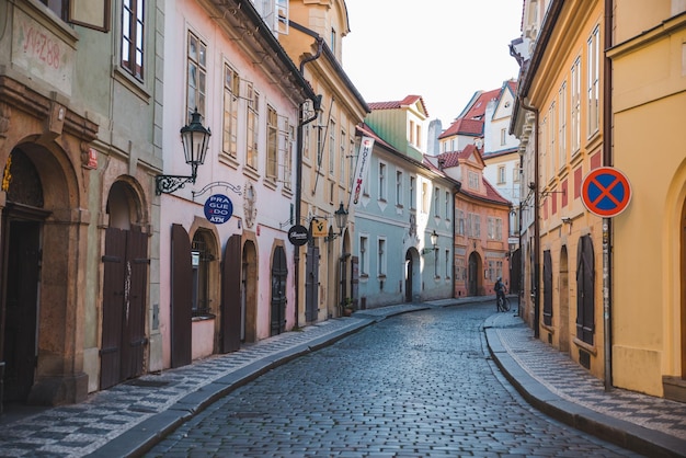 Empty street in european city with woman bicyclist in the end