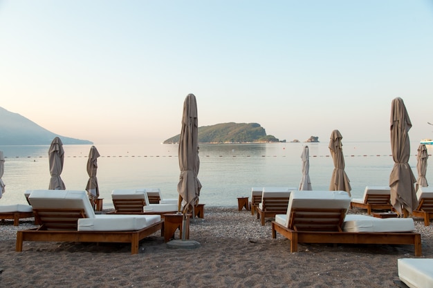 Empty sunbeds on the beach, the beginning of the tourist season, waiting for vacationers during quarantine.