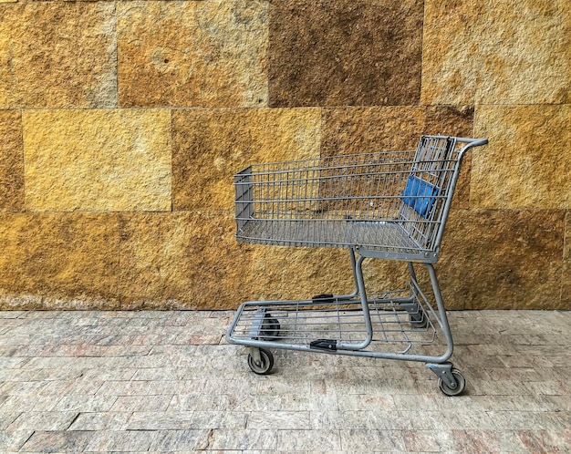 Empty supermarket trolley  cart  On Floor Against Wall