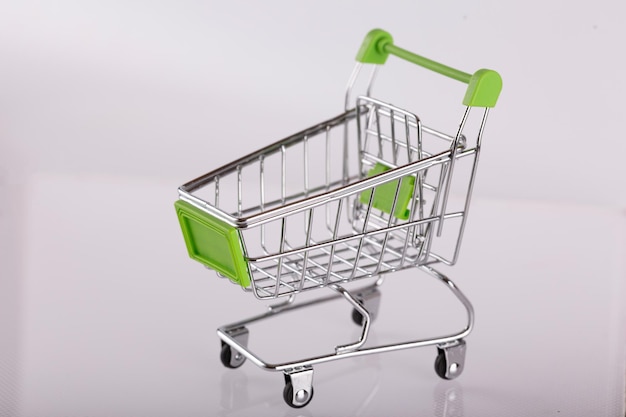 Empty supermarket trolley on white background, close-up