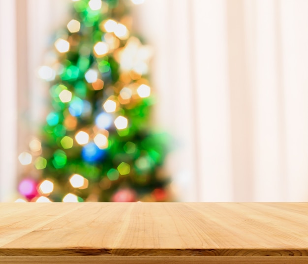 Empty table top with blurred Christmas tree with bokeh light background