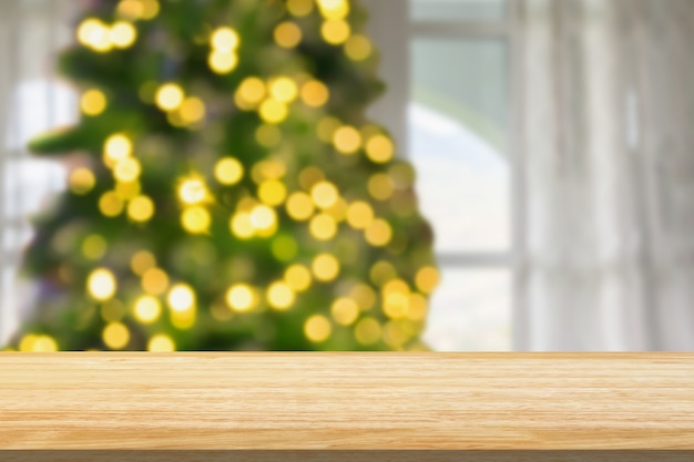 Empty table top with blurred Christmas tree with bokeh light background