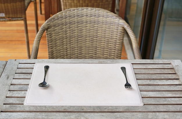 Empty table with spoon and fork in the restaurant