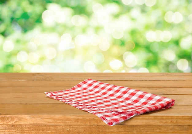 Empty table with a tablecloth over beautiful nature background