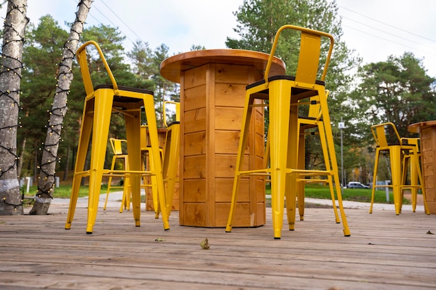 Empty tables and chairs on the terrace of an outdoor outdoor cafe