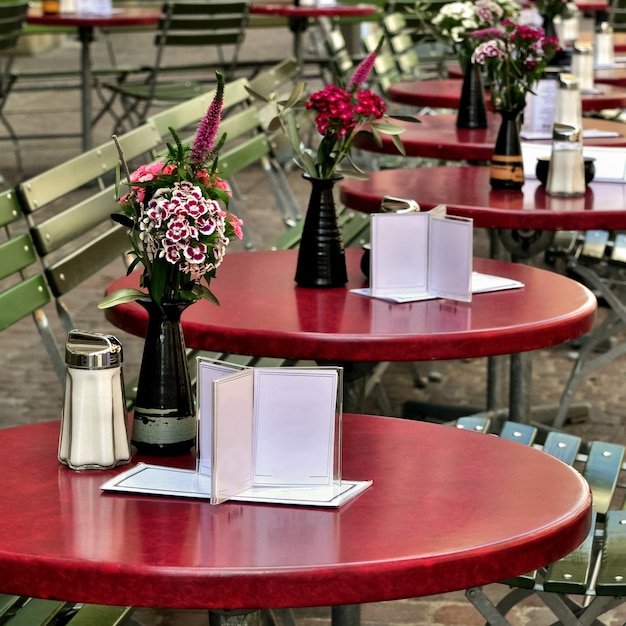 Photo empty tables of street cafe decorated with flowers