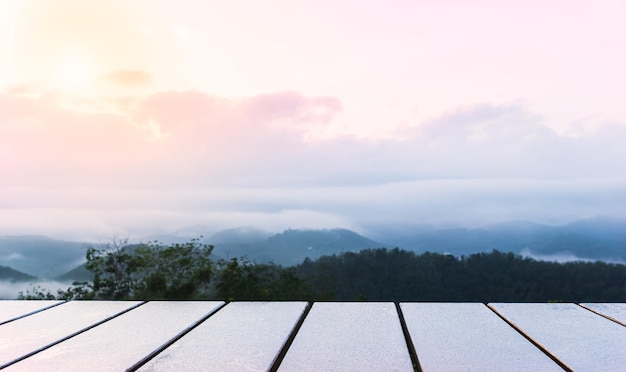 Empty terrace wood floor with sunset sky in the morning and fog sunlight clouds in the morning