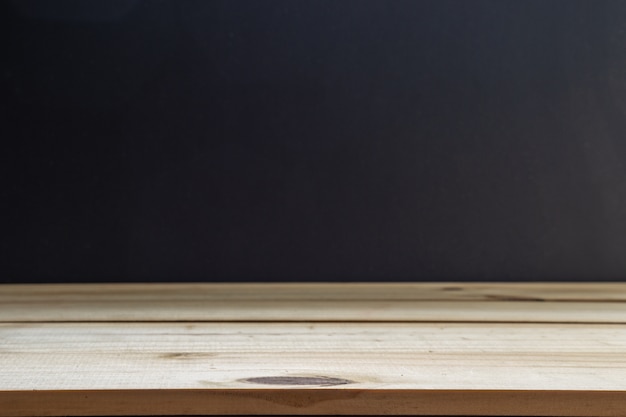 Photo empty top shelves or table wood on blackboard background.