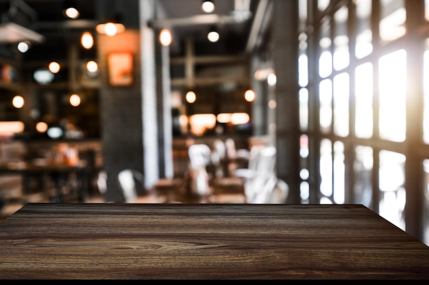 Empty top of wooden shelves on coffee shop tree front view background For product display blur background