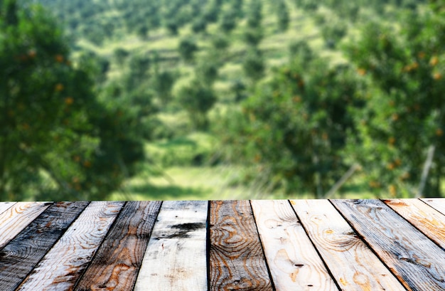 Empty top wooden table and sunny abstract blurred background