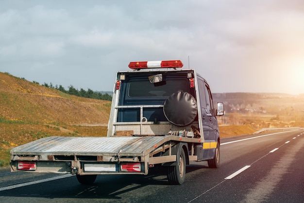 Empty tow truck with drives down a highway