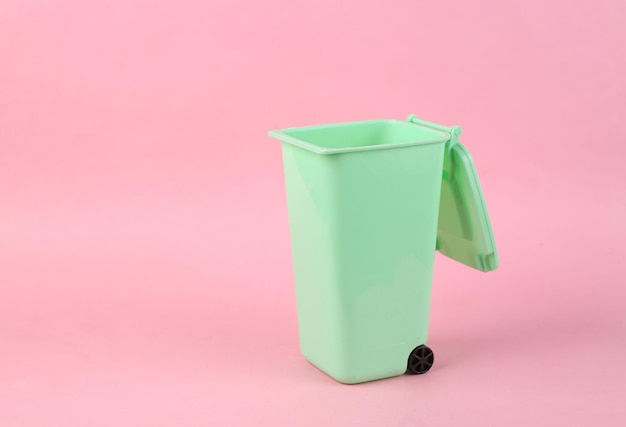 Empty toy trash can on pink background